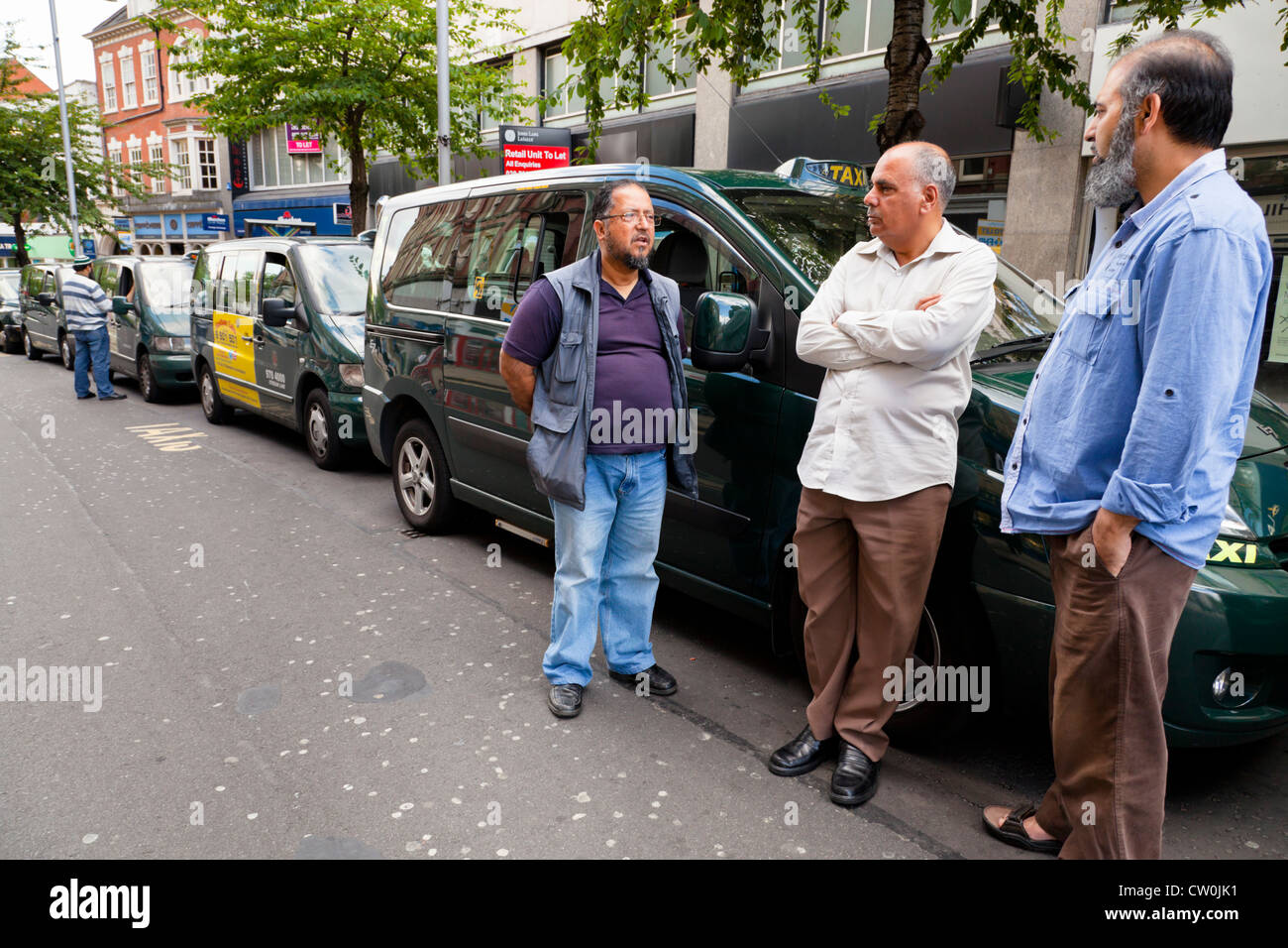 Hay una parada de taxis. Los taxistas esperando una tarifa junto a sus taxis, en el centro de la ciudad de Nottingham, Inglaterra, Reino Unido. Foto de stock