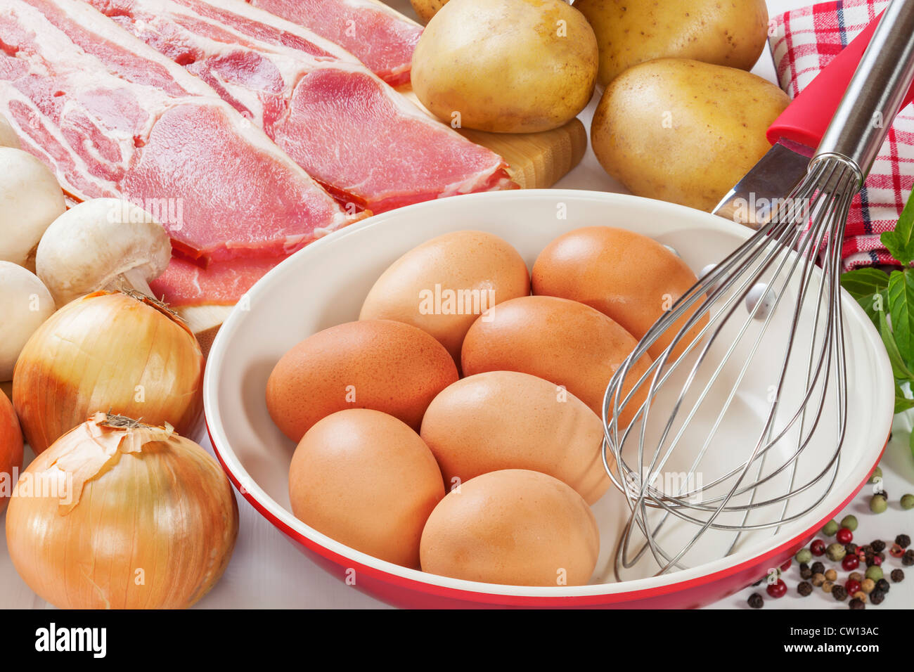 Ingredientes de frittata con bacon, patatas, setas y cebolla. Foto de stock