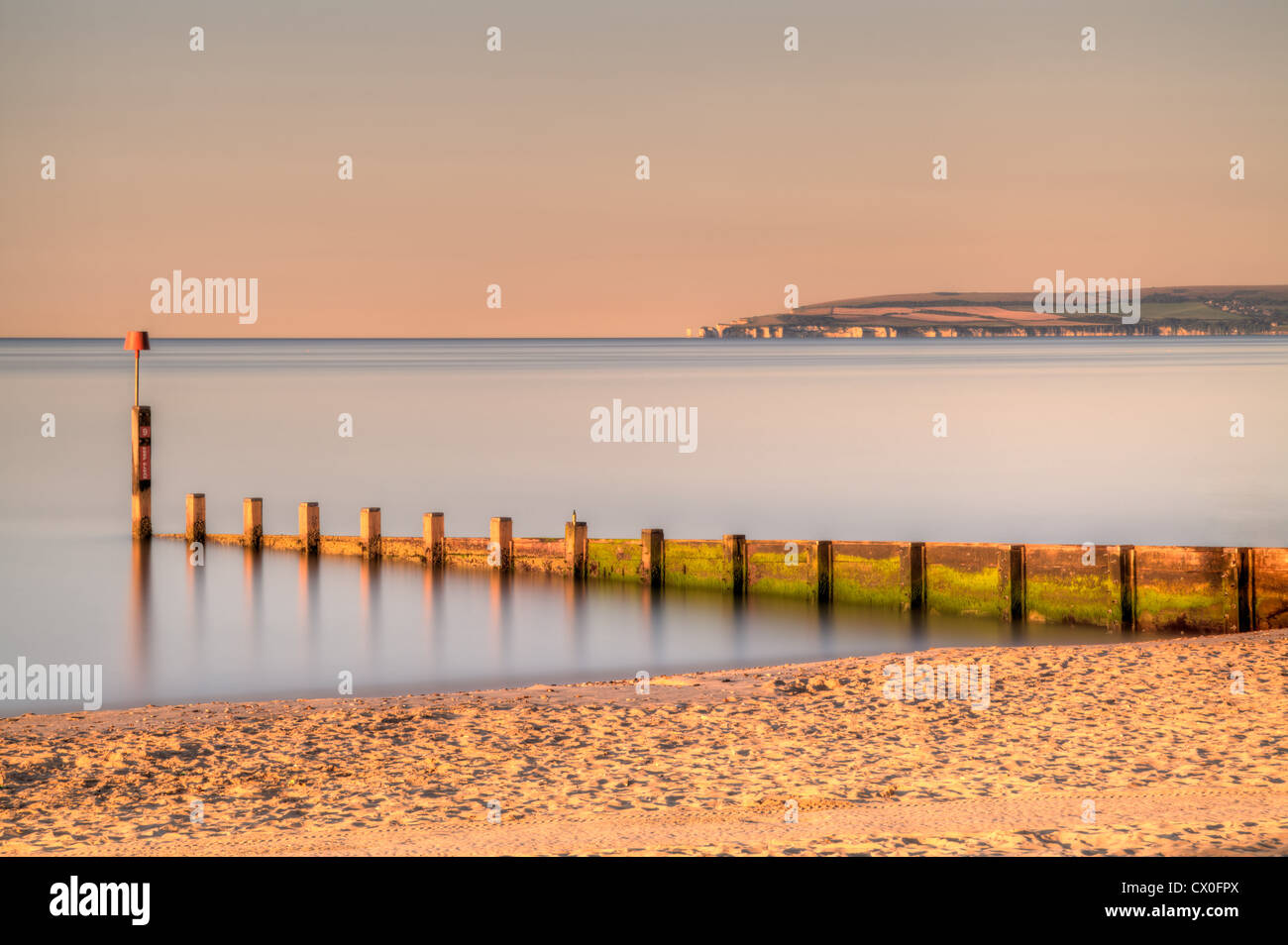 Temprano en la mañana la luz sobre la playa de Bournemouth con viejos Harry en la distancia, Inglaterra Foto de stock