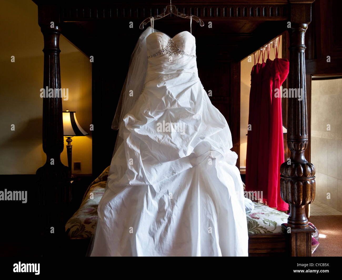 El tradicional vestido blanco cuelga de una cama con dosel Fotografía de  stock - Alamy