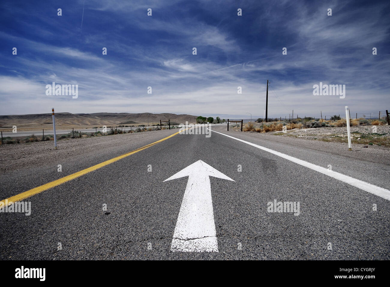 Una flecha en una carretera como un concepto que nos llevan a seguir adelante Foto de stock
