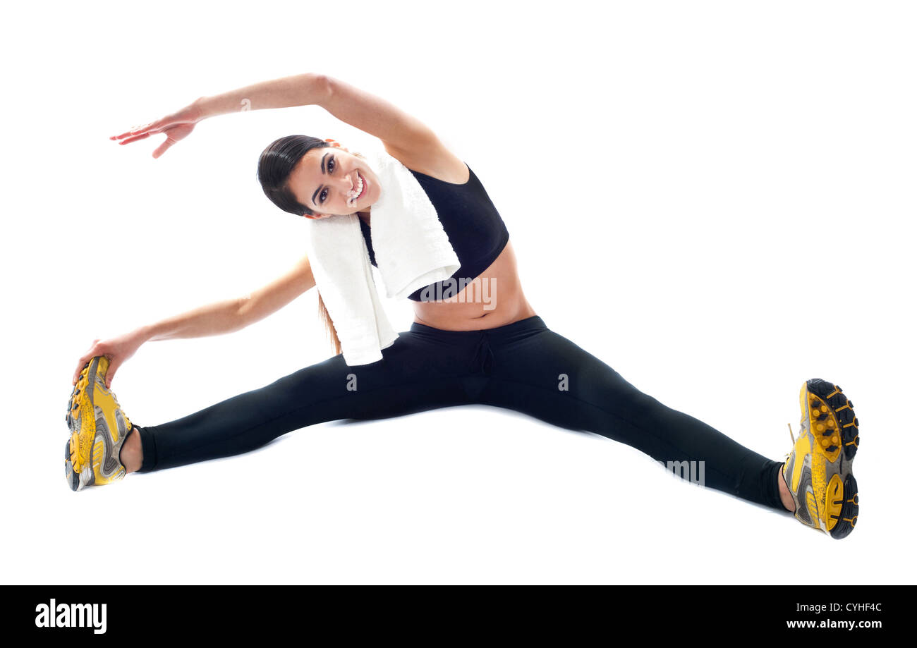 Adolescente deportivo haciendo ejercicios de flexibilidad. Todo sobre fondo blanco. Foto de stock