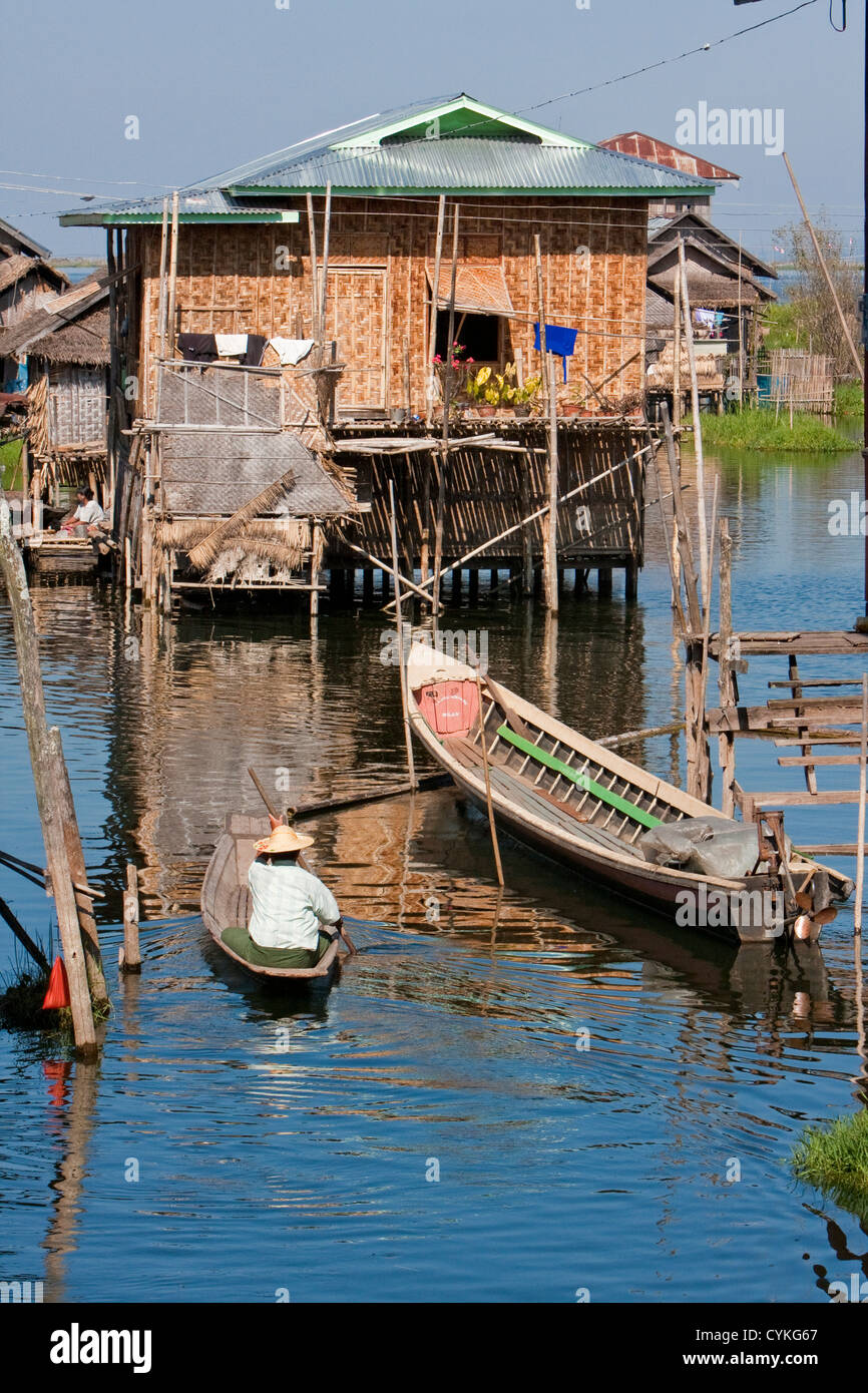 Myanmar, Birmania. Escena de aldea, casa sobre zancos, el transporte por barco, el Lago Inle, el Estado de Shan. Foto de stock
