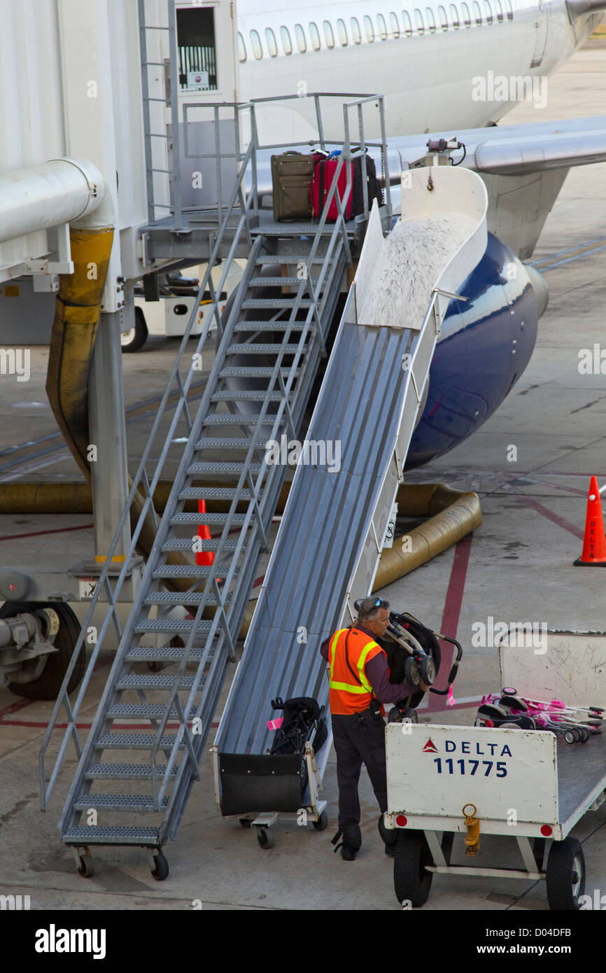 Equipaje EQUIPAJE cargas miembro de la tripulación a bordo de las aeronaves sobre el asfalto Foto de stock