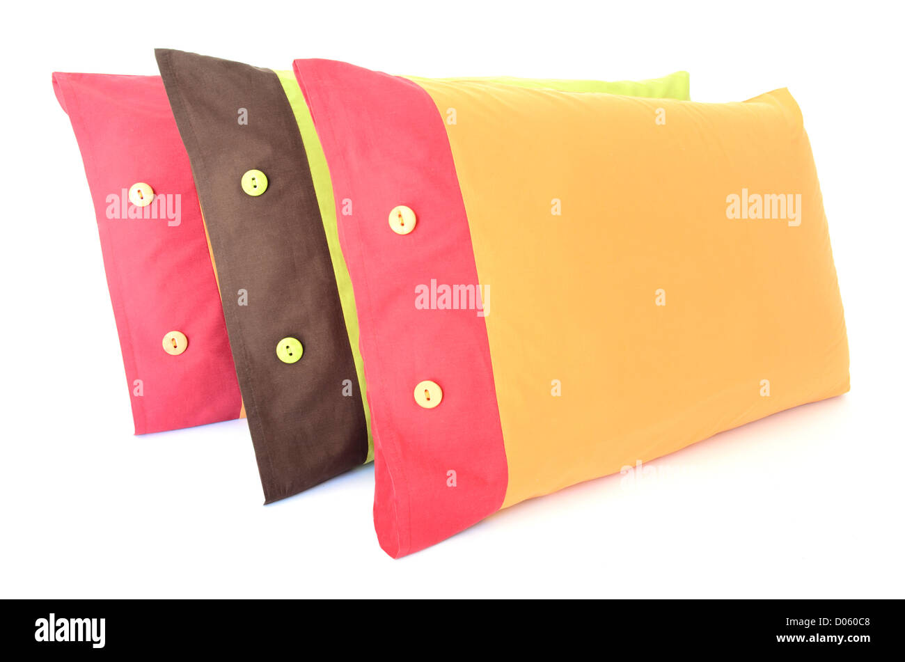 Tres almohadas de colores con botones aislado en blanco Foto de stock