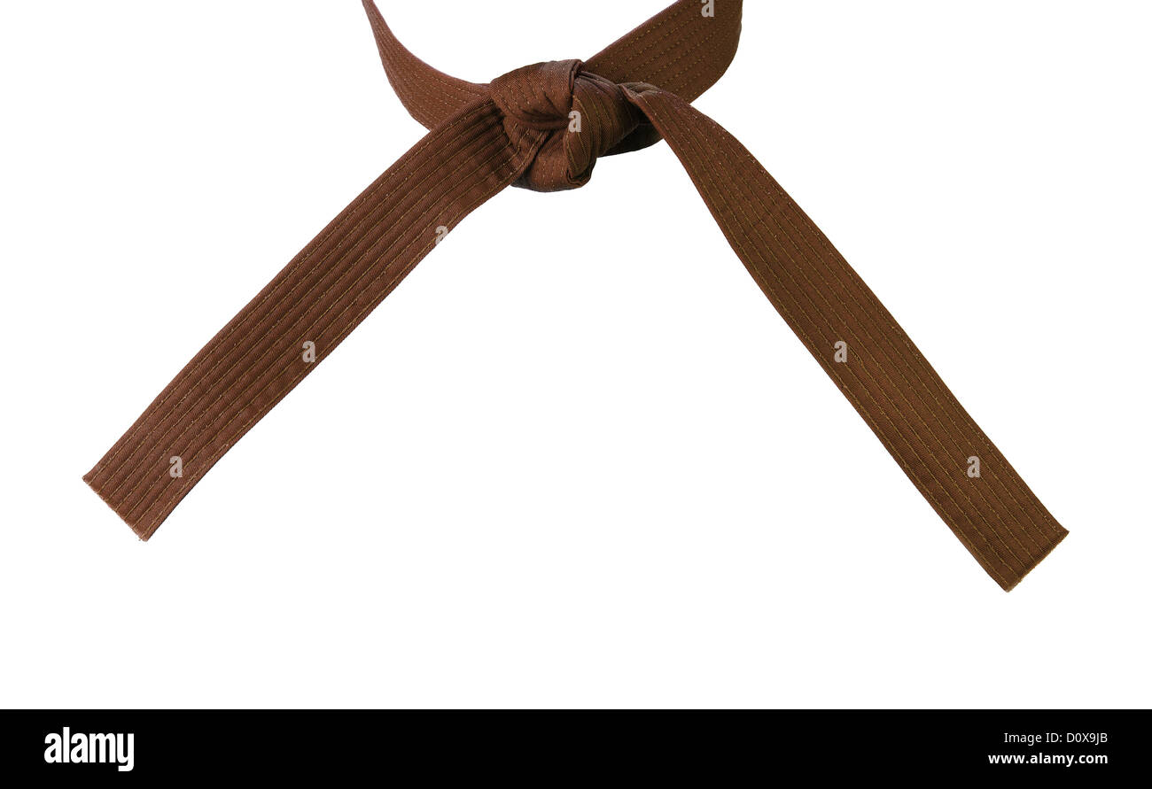 Atado cinturón marrón en karate closeup aislado sobre fondo blanco  Fotografía de stock - Alamy