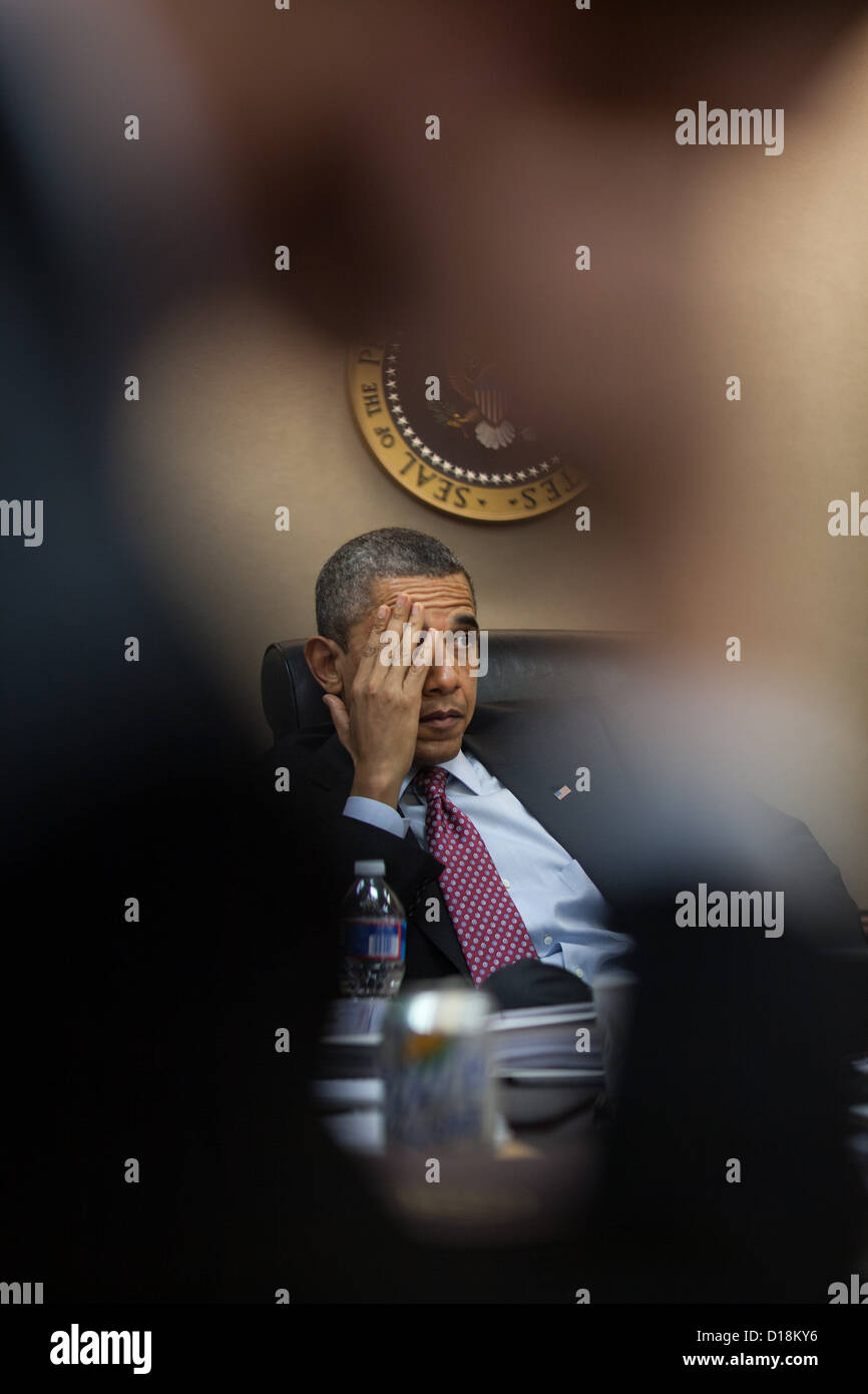 El presidente Barack Obama es informado con anticipación de su viaje a la República de Corea durante una reunión en la Sala de Situación de la Foto de stock