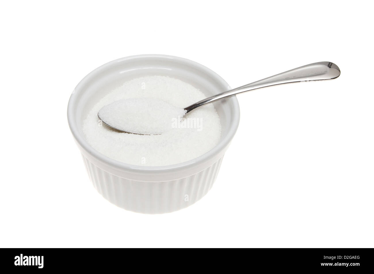 El azúcar granulado con una cuchara en un tazón Foto de stock
