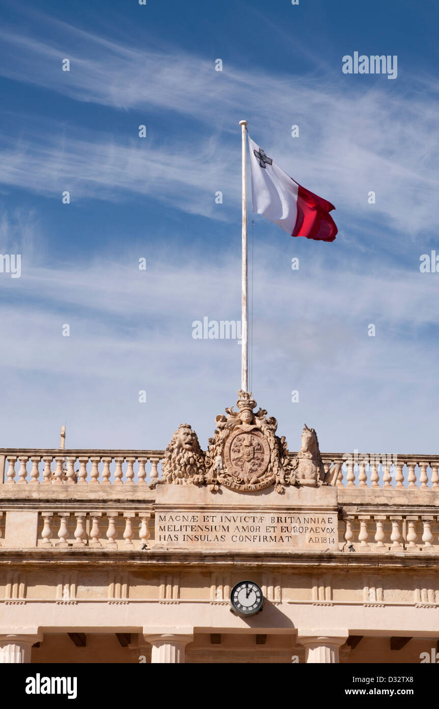 La Valetta, Malta, albergue, Centro de Valletta, edificios públicos, la bandera maltesa volando sobre un mástil en la cima del edificio Foto de stock