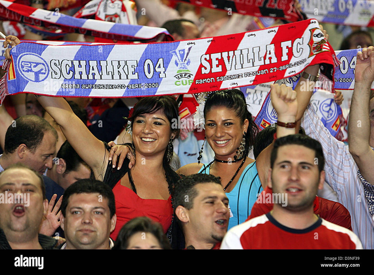 Dos mujeres hinchas sostener una bufanda impresa con los nombres de ambos  equipos durante la Copa de la UEFA de segunda pierna semifinal partido FC  Schalke 04 vs. FC Sevilla, Sevilla, España,
