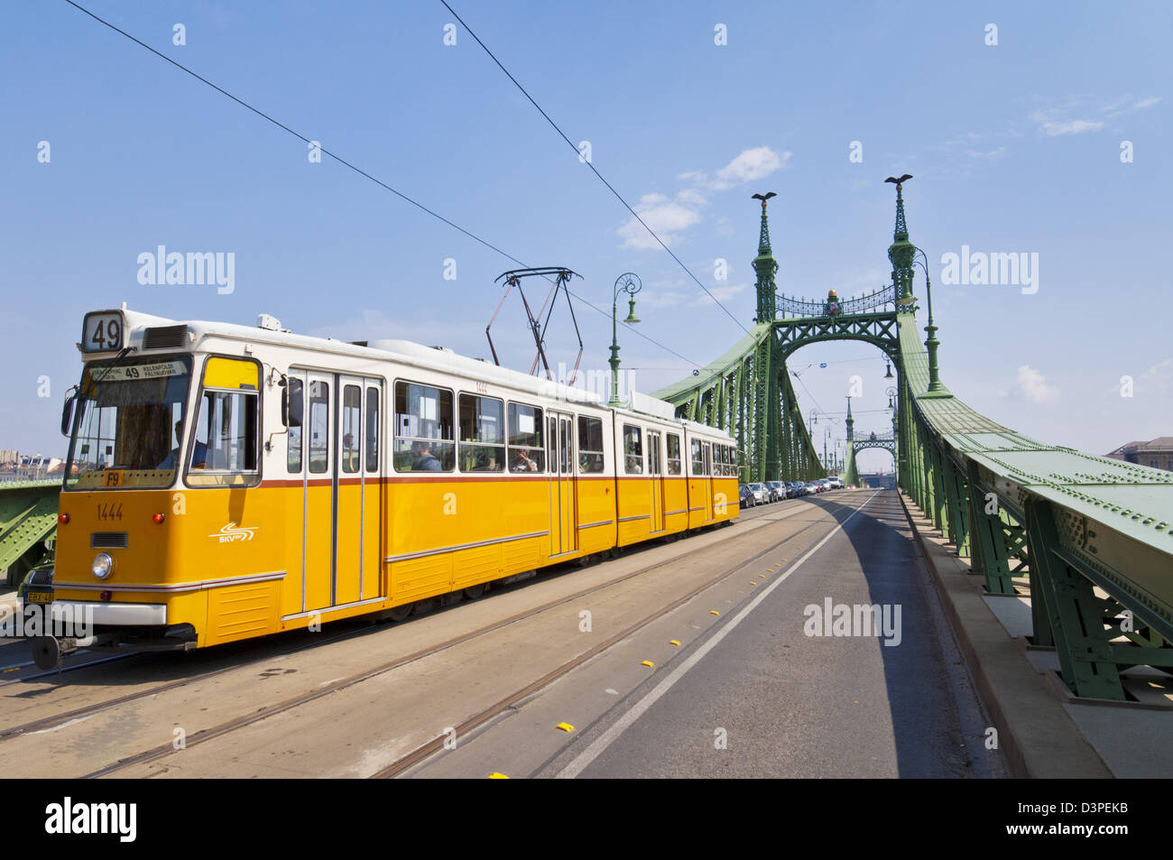 Amarillo de tranvía de la ciudad cruzando el puente de la libertad en Budapest, Hungría, Europa, UE Foto de stock