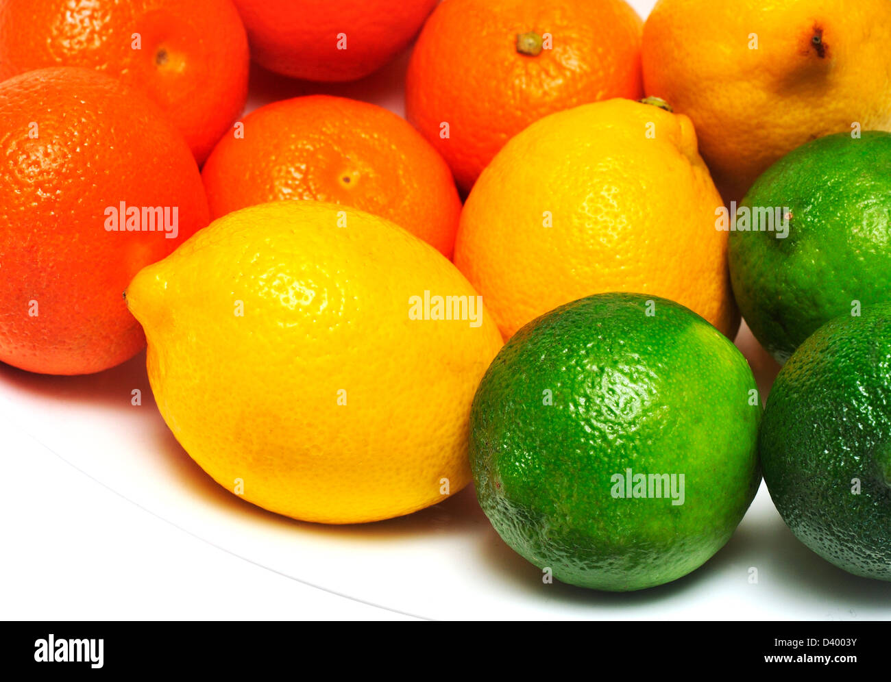 Mandarinas, limones y limas en un tazón. Foto de stock