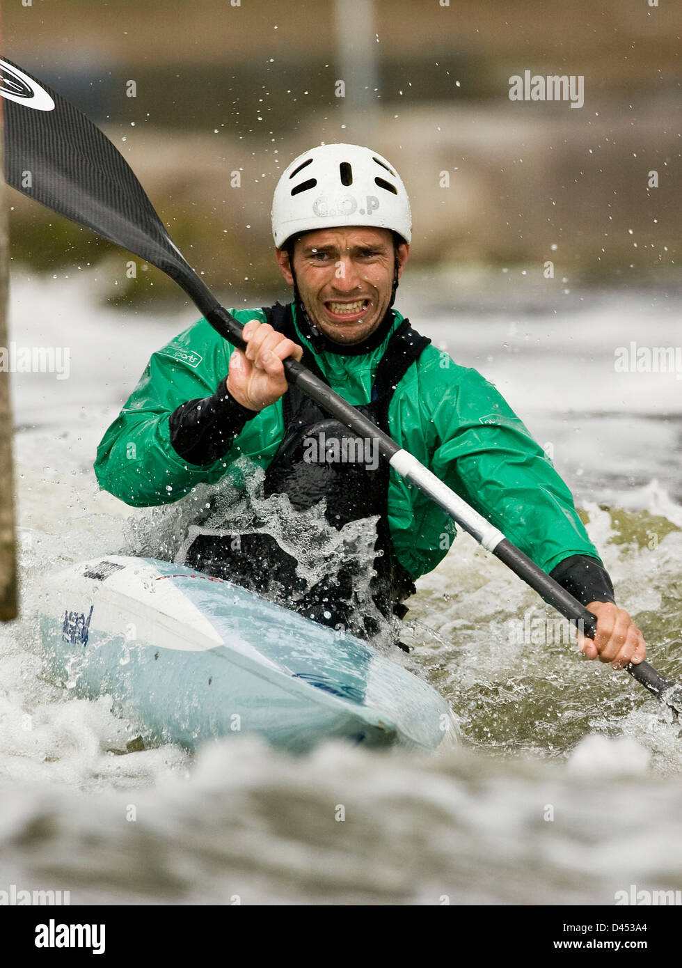 Hombre remando en canoa con esfuerzo en Río fluyendo Foto de stock