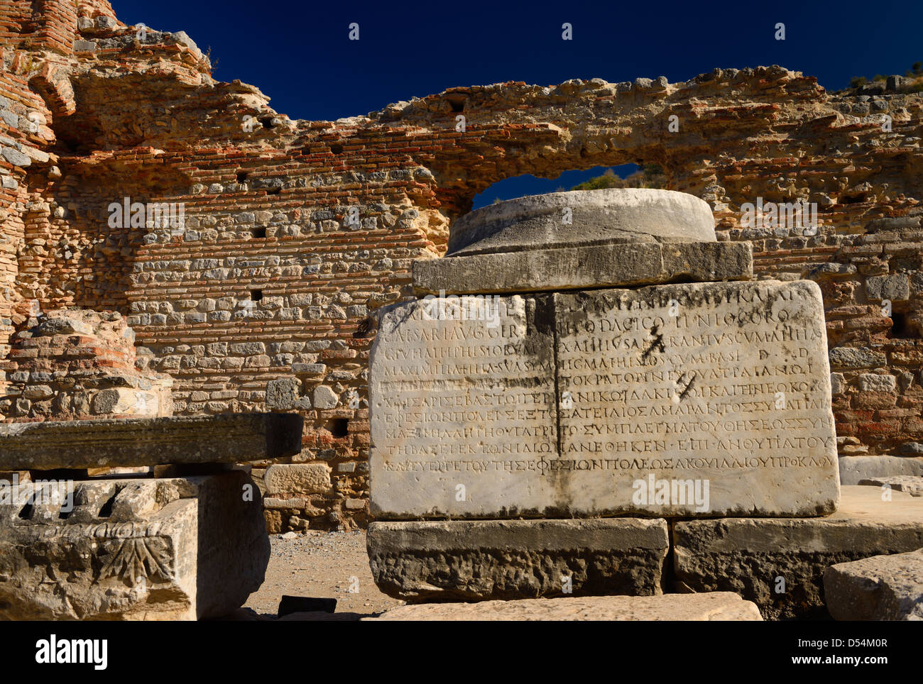 Inscripción griega sobre la base de la columna de piedra en la pared del burdel en Curetes y calles de mármol de la antigua Éfeso Turquía Foto de stock