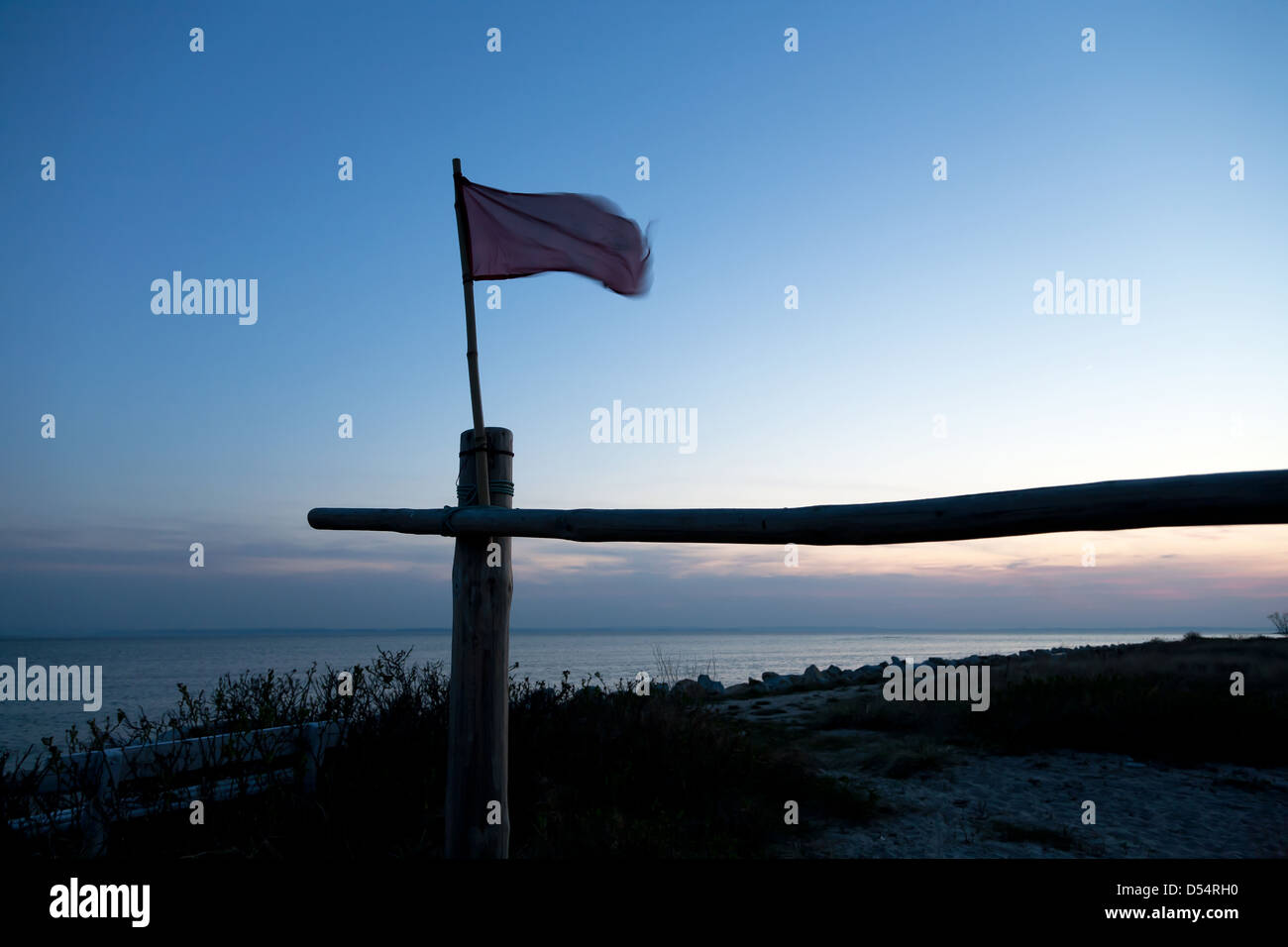 Kuznica, Polonia, señal bandera ondea en el crepúsculo del Golfo de Gdansk Foto de stock