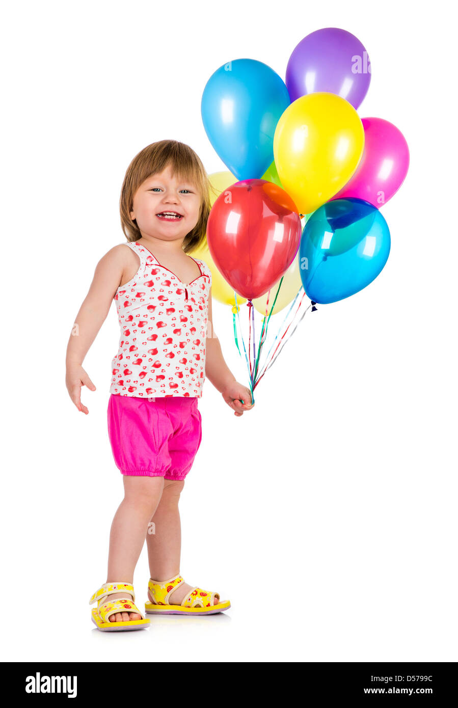 Niña sonriente con globos sobre fondo blanco. Foto de stock