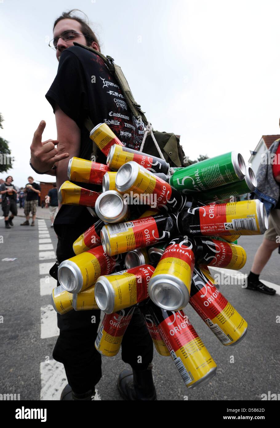 Un festival visitante muestra su colección de latas de cerveza vacías en el heavy metal más grande del mundo en el festival Wacken, Alemania, 06 de agosto de 2010. Hasta el 07 de agosto de 2010, más de 75.000 'metalheads' parte en el festival en el pequeño pueblo de Wacken, donde sólo viven unas 1.800 personas. Foto: CARSTEN REHDER Foto de stock