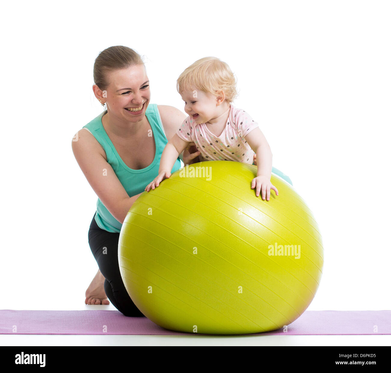 Madre haciendo gimnasia con el bebé sobre la bola de fitness Foto de stock