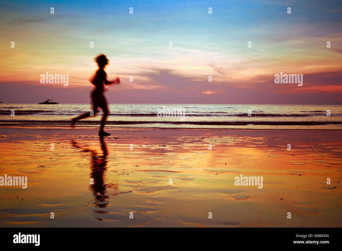 Ejecutar a propósito, mujer silueta en la playa Foto de stock