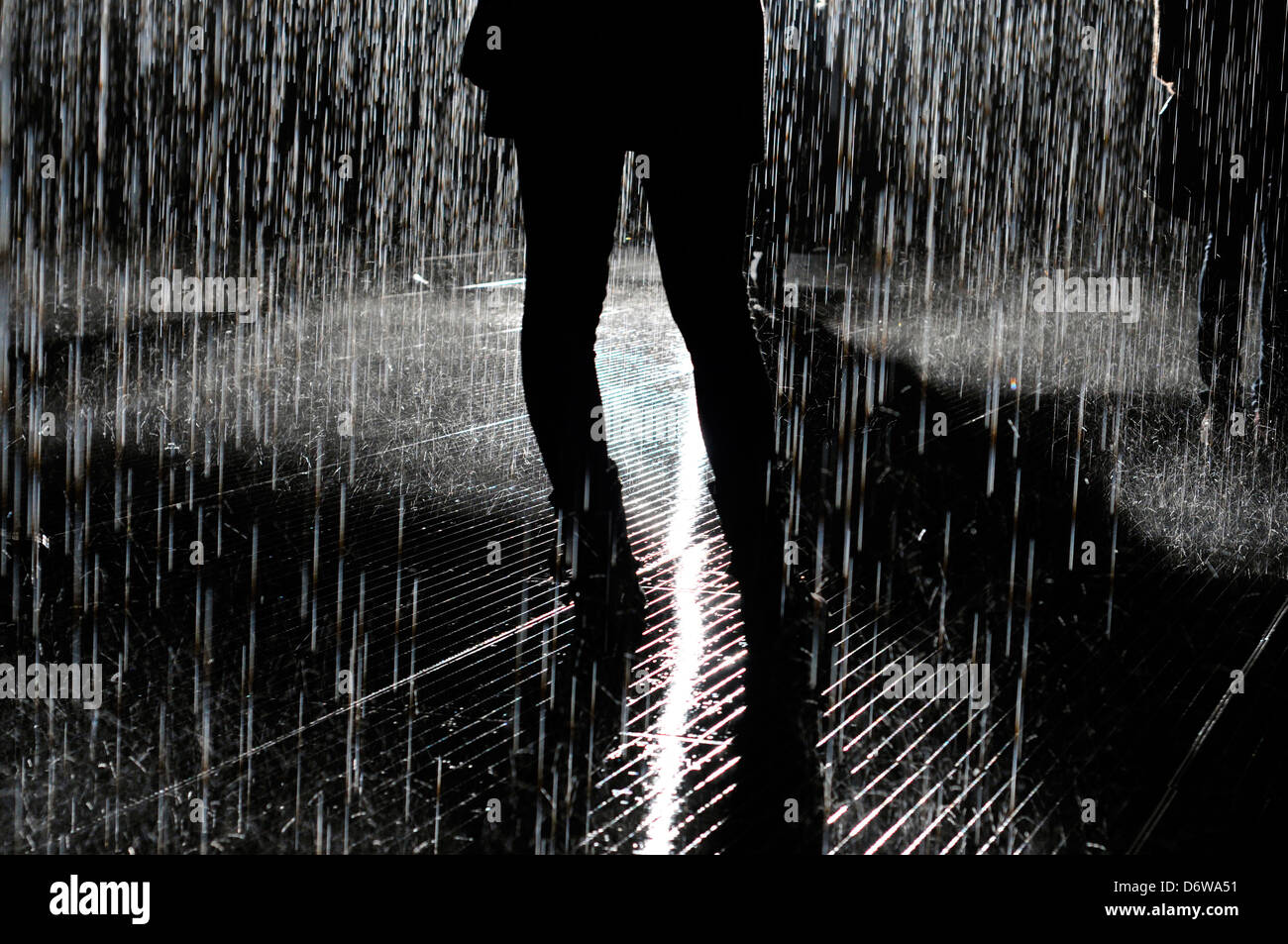 Una mujer en silueta en la "sala de la lluvia" en el Barbican Center Foto de stock
