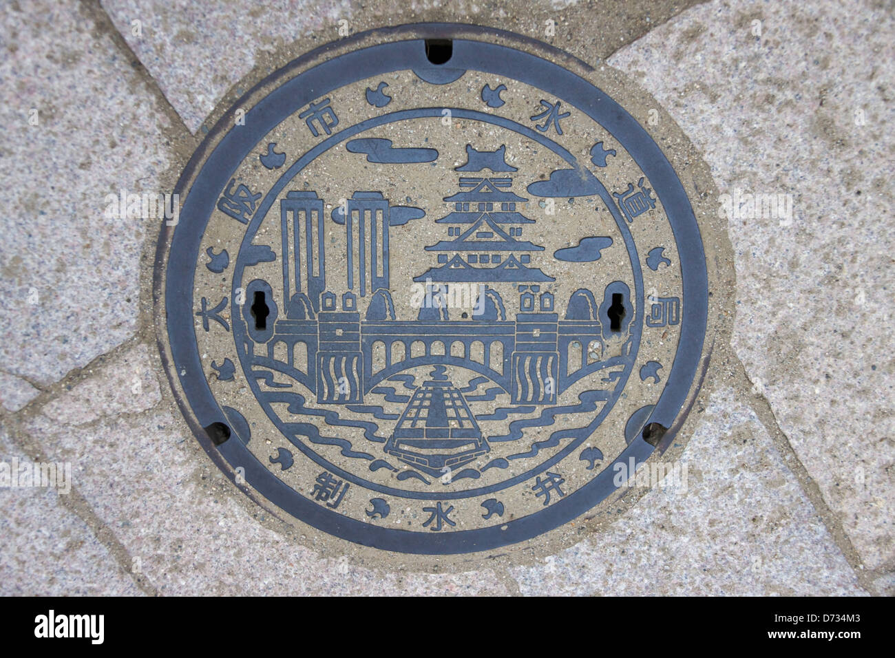 Tapa de alcantarilla representando el horizonte de Osaka, Osaka, Japón Foto de stock