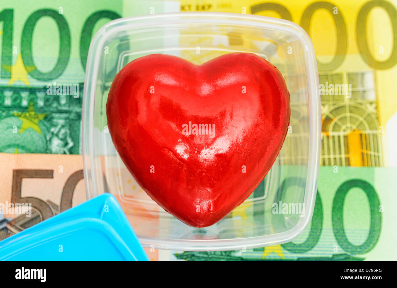Corazón mantenga fresca en caja con billetes de banco, fotografía simbólica del comercio de órganos Foto de stock