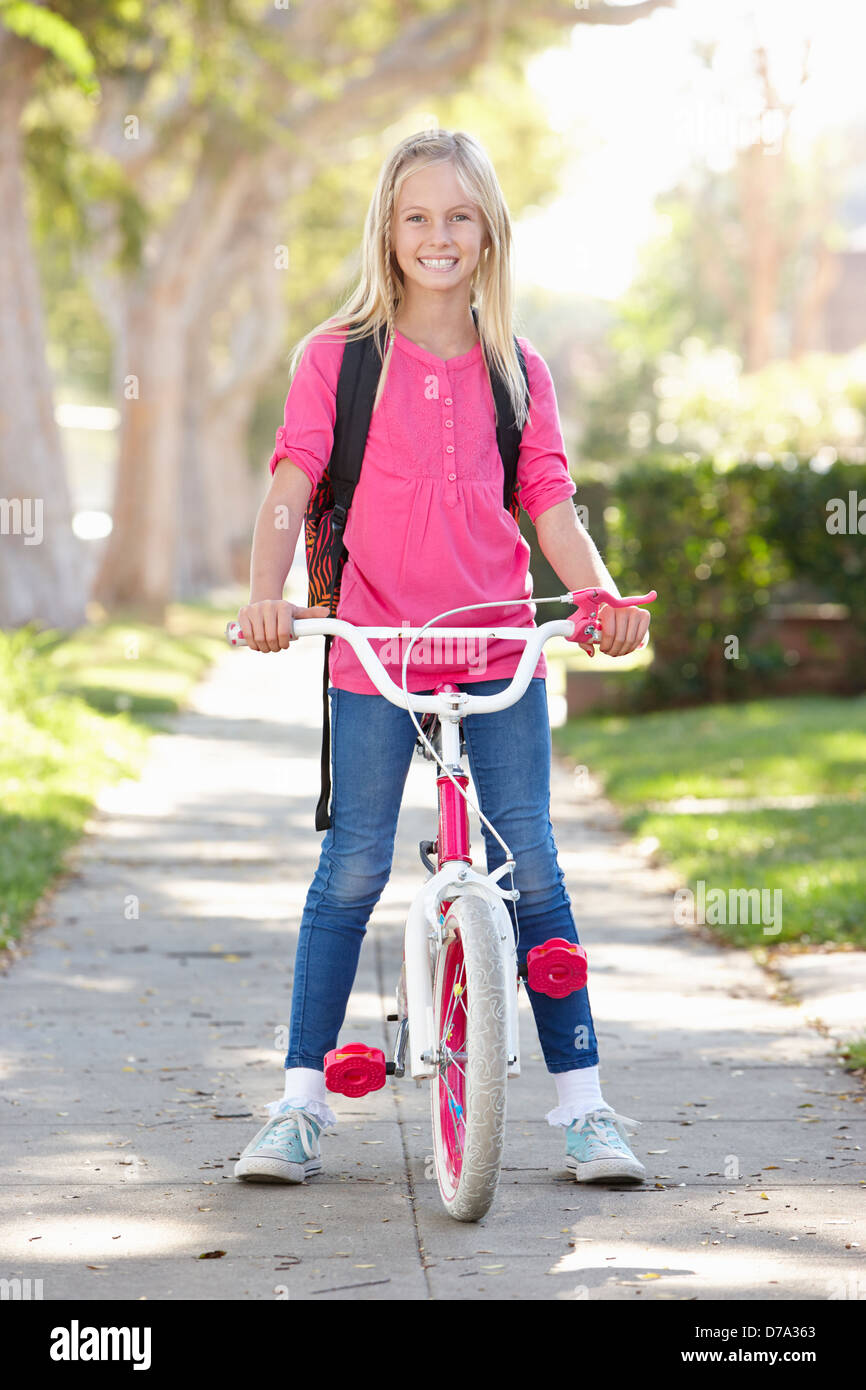 Chica que llevaba la mochila a la escuela de ciclismo Foto de stock