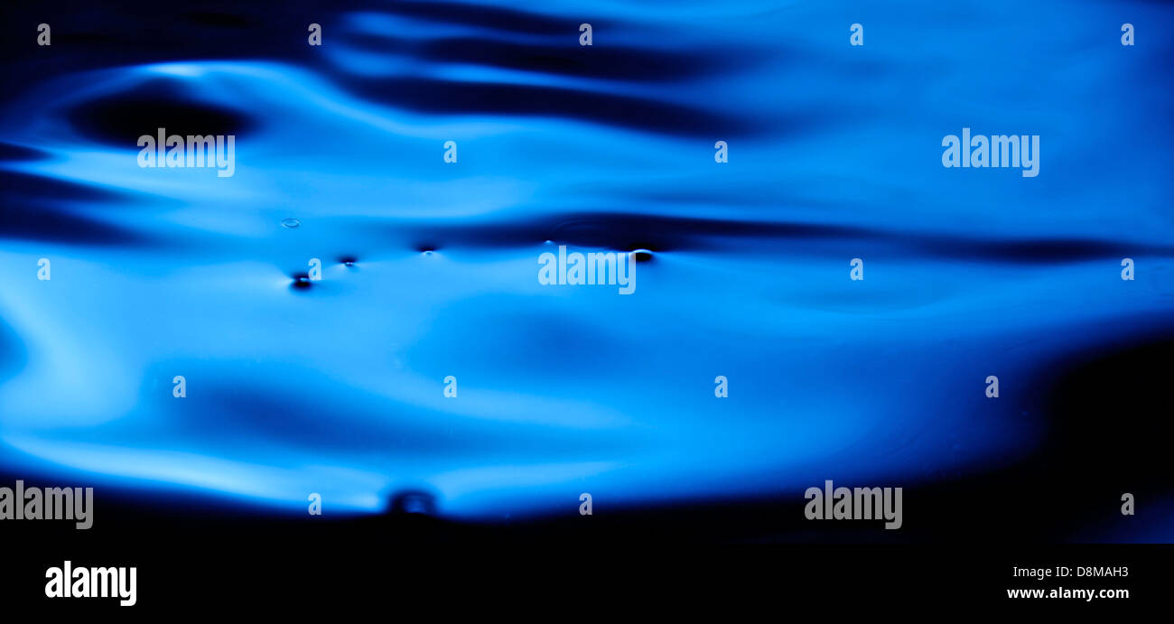 Burbujas en el agua azul con sombras oscuras. Foto de stock