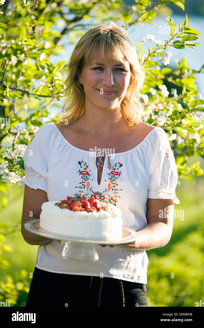 Mujer con una tarta de fresas, Fejan, archipiélago de Estocolmo, Suecia. Foto de stock