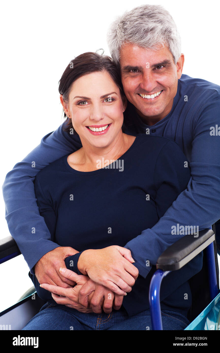 Apoyo cariñoso esposo abrazando a minusválidos esposa aislado en blanco Foto de stock