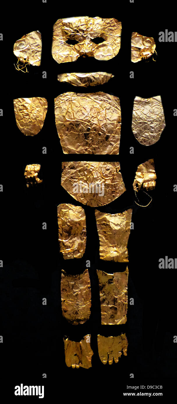 Un único oro sirve para cubrir el cuerpo y el rostro de un niño, compuesto de piezas de lámina de oro. Un detalle distintivo son los aretes con forma de anillo. Foto de stock
