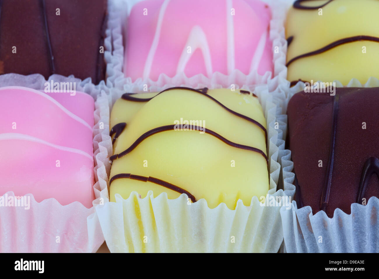 Fondant caprichos - pequeño individuo iced bizcochos de cerca. Foto de stock