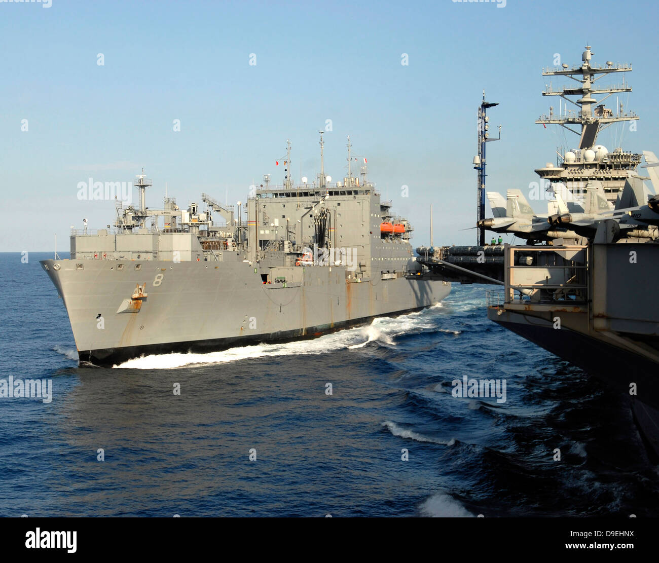 Carga Seca y municiones buque USNS Wally Schirra tránsitos junto con el portaaviones USS Nimitz. Foto de stock