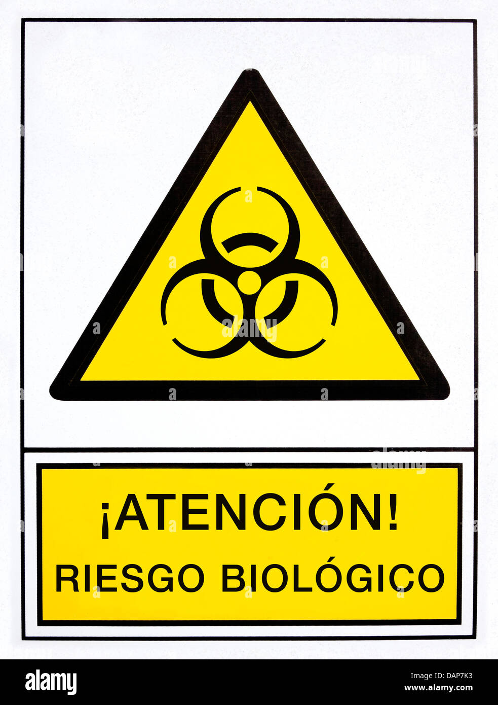 Atención, la señal de peligro biológico en idioma español Foto de stock