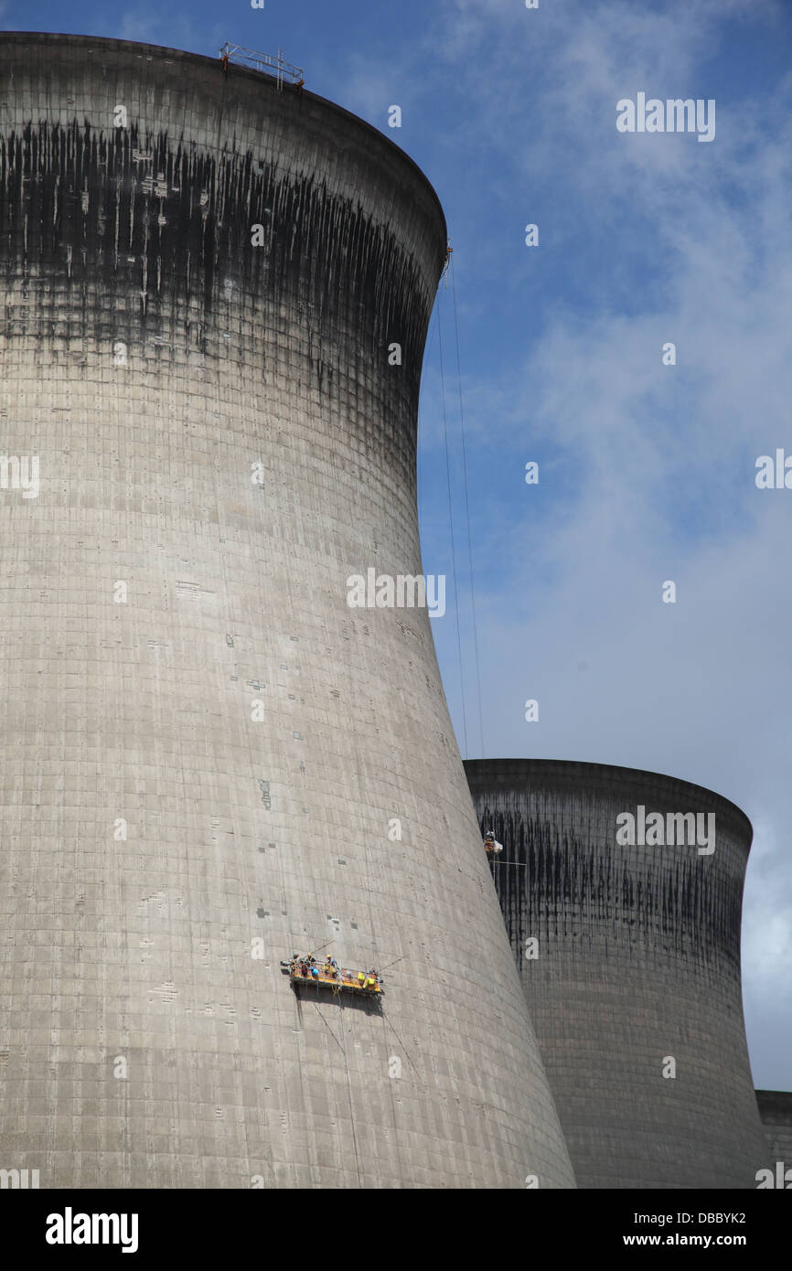 Los equipos de mantenimiento trabajo de cunas suspendido sobre una de las torres de refrigeración en Ferrybridge gigante Power Station, West Yorkshire, Reino Unido Foto de stock