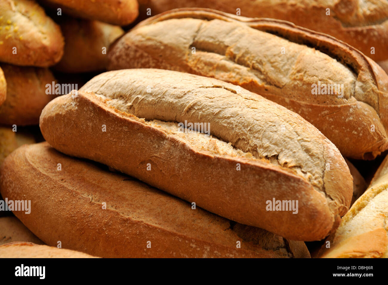 Hogazas de pan fresco respaldado apiladas para la venta Foto de stock
