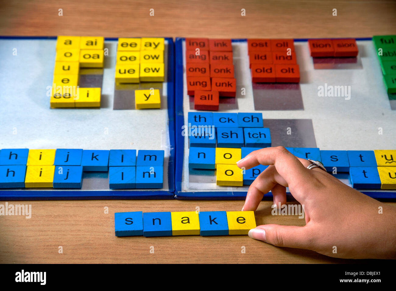 Un certificado de especialista en pruebas de dislexia en una oficina en casa utiliza manipulación de mosaico de color para un enfoque multisensorial ortografía Foto de stock