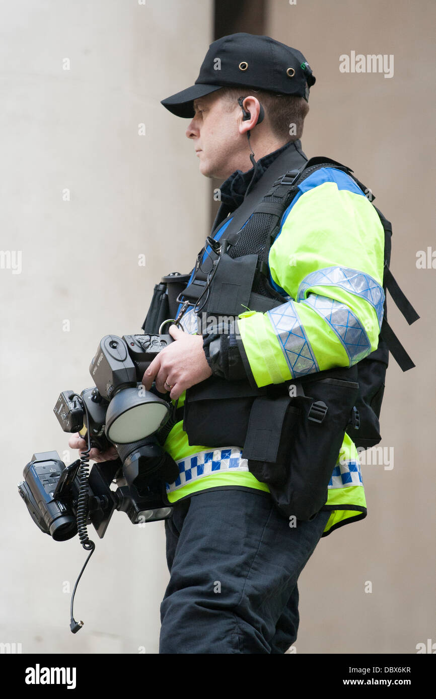 Un policía con cámara y equipo de video en protesta fuera del G20 en Londres el Banco de Inglaterra Foto de stock