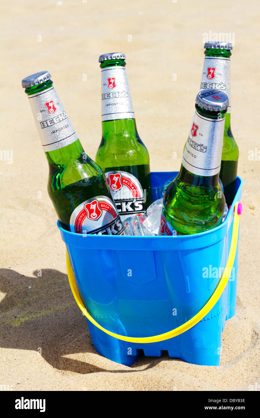 Beck botellas de cerveza con hielo en el castillo de arena en la playa de la cuchara. Foto de stock