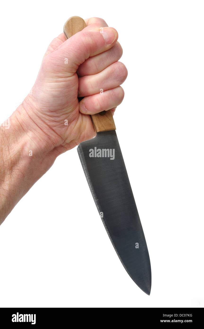 Mano sosteniendo y apuñalado con un cuchillo Foto de stock