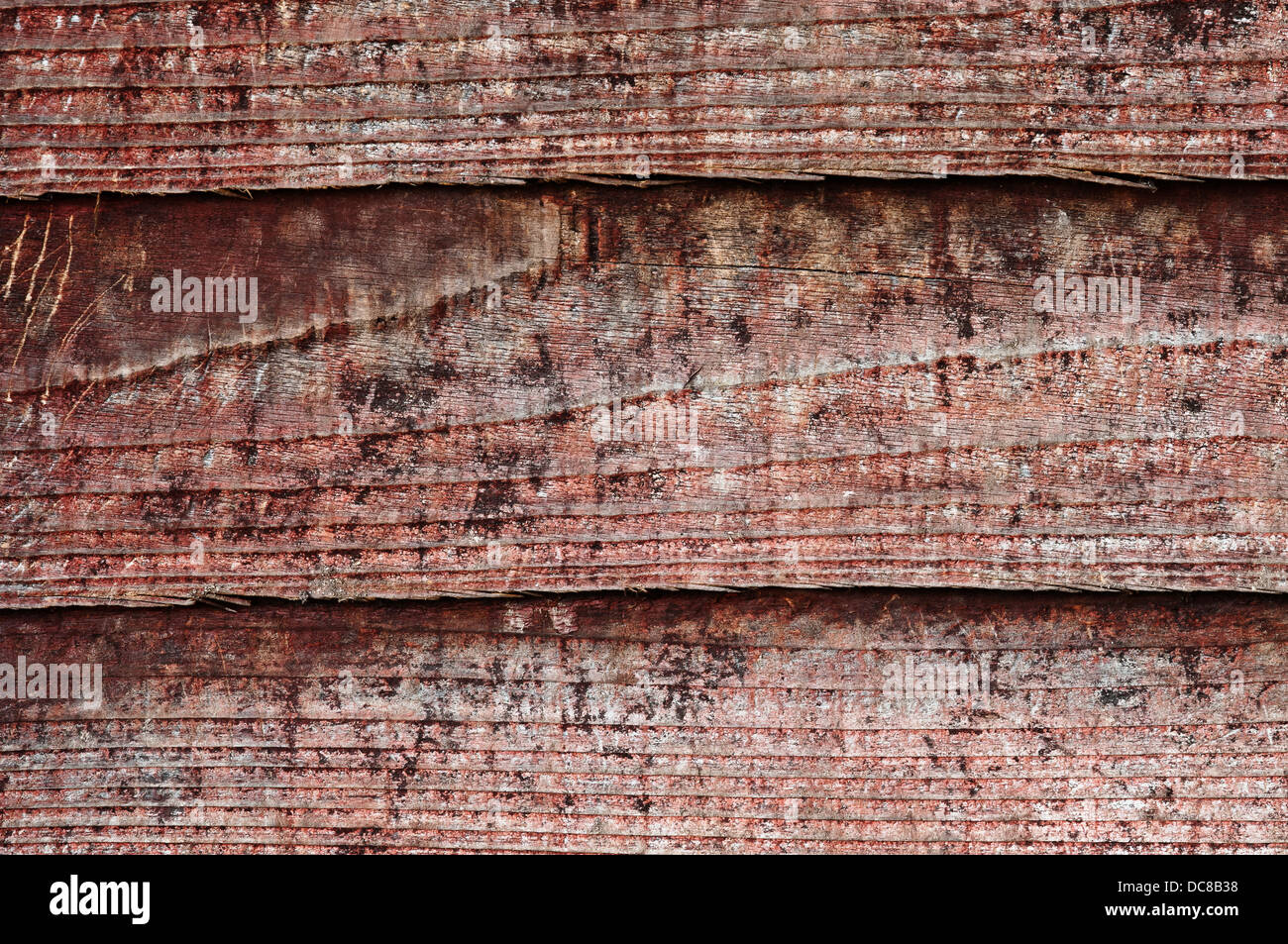 La textura de la madera, con aspecto erosionado, viejo y rojo oscuro - Vintage Foto de stock