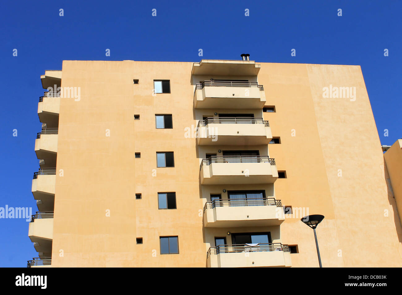 Vista lateral del moderno edificio hotelero español con fondo de cielo azul. Foto de stock