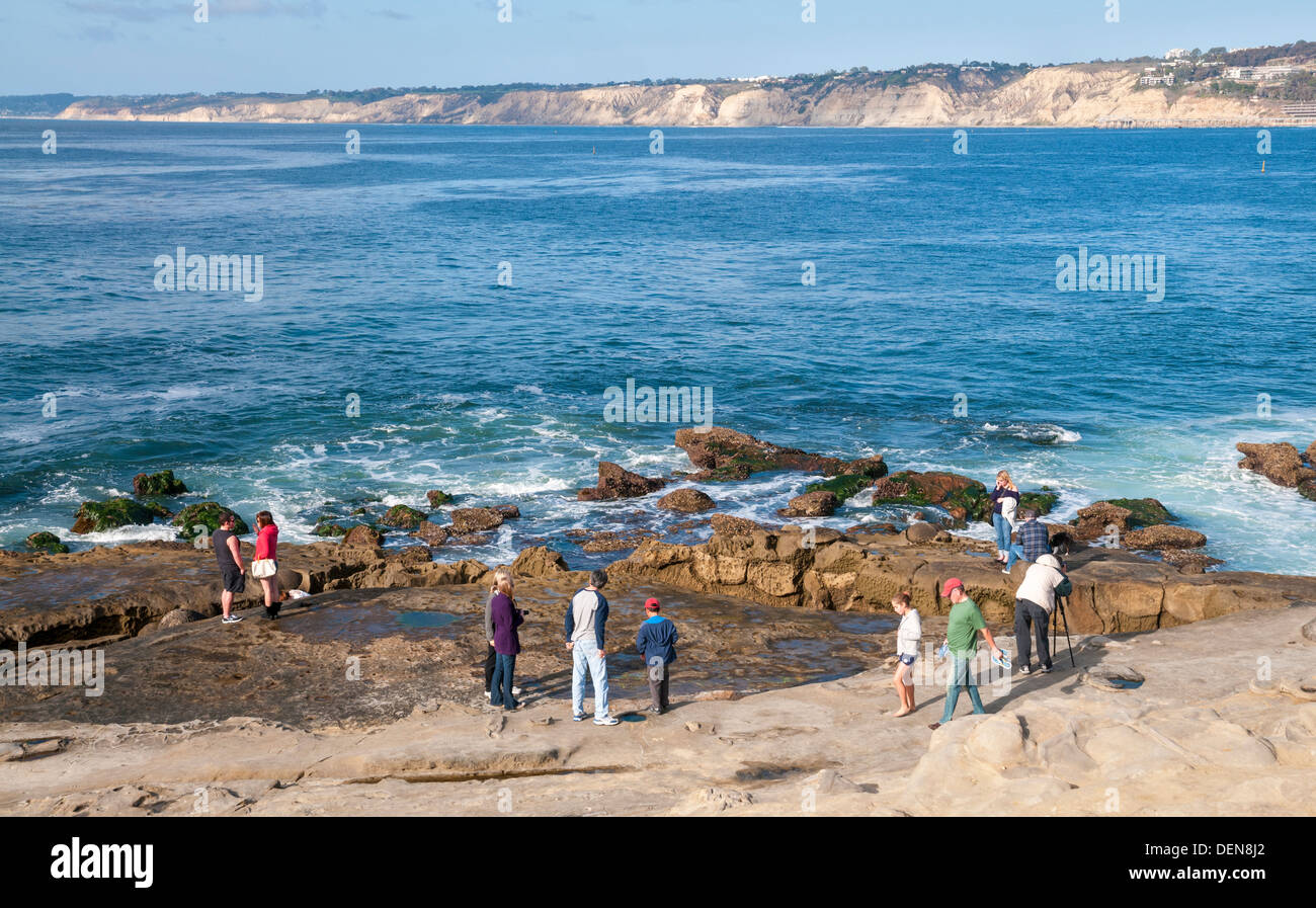 En La Jolla, California, los visitantes que exploran las piscinas de marea Foto de stock