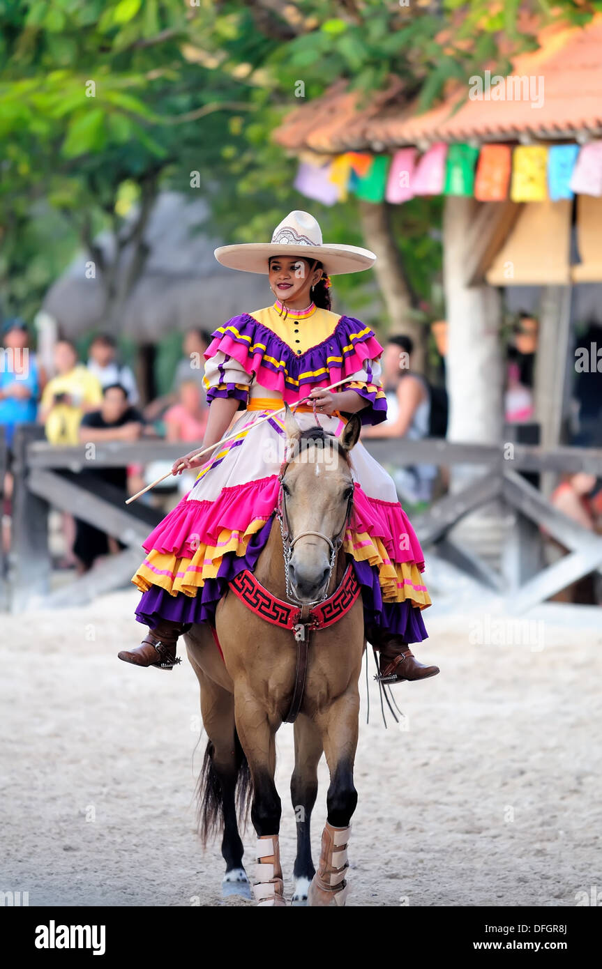 Sonriente mujer mexicana en traje tradicional a caballo Foto de stock