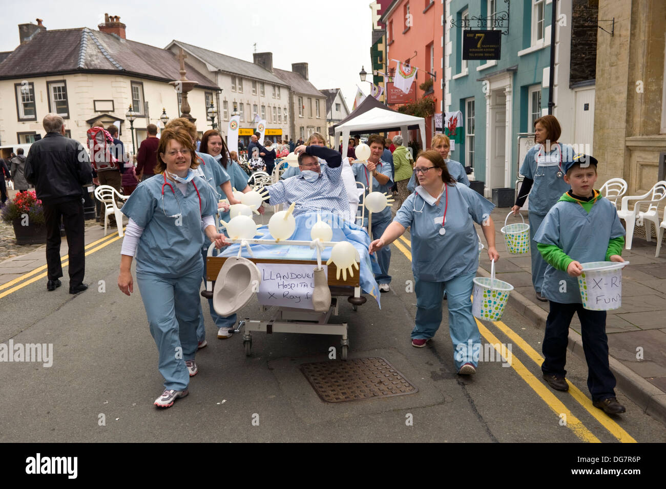 Enfermeras y médico de caridad para recaudar dinero para empujar la cama de hospital de la máquina de rayos X en Llandovery Carmarthenshire South West Wales UK Foto de stock