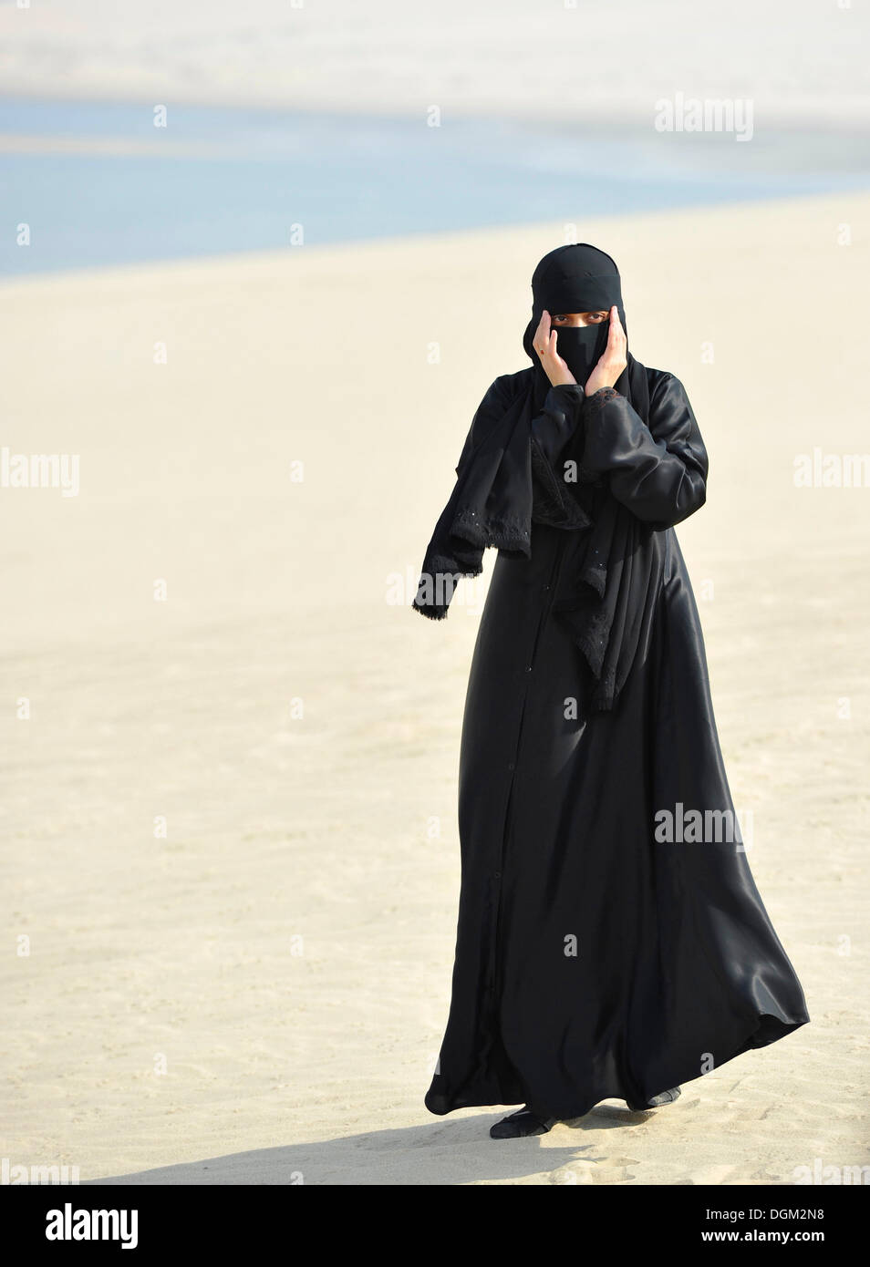https://c8.alamy.com/compes/dgm2n8/mujer-arabe-en-vestimentas-tradicionales-con-velo-y-abayah-khor-al-udeid-playa-khor-el-deid-mar-interior-el-milagro-del-desierto-de-qatar-dgm2n8.jpg
