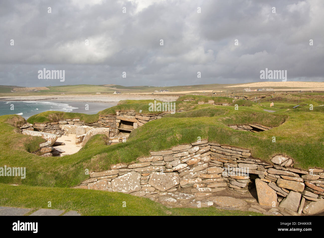 Las islas de Orkney, Escocia. El asentamiento neolítico de Skara Brae, en la Bahía de Skaill en el fondo. Foto de stock