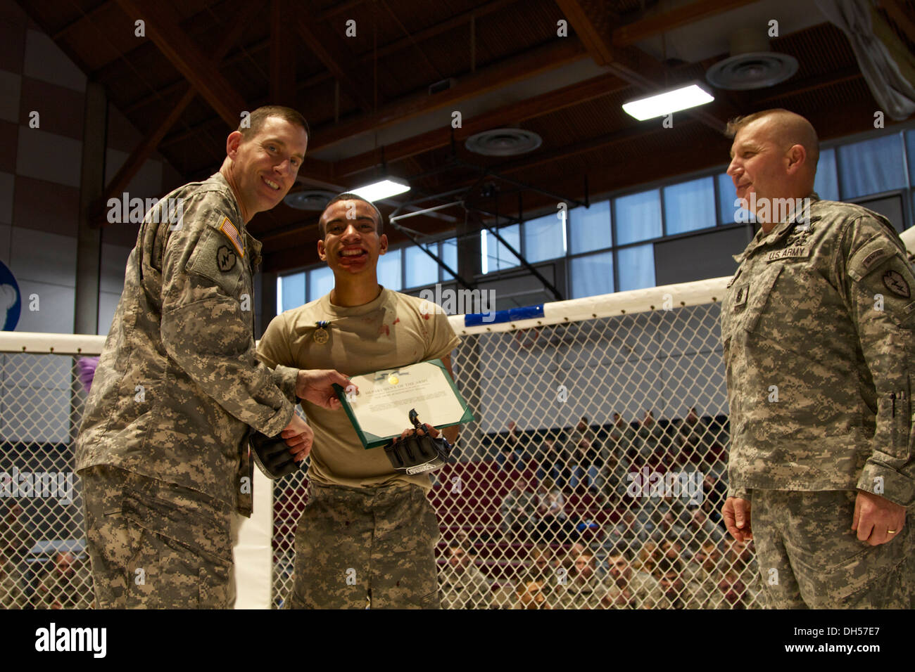Col Brian Reed, comandante de la 1/25, presenta SBCT PFC. Jake de Marte, un contendiente ligero de la brigada, batallón de tropas con un ejército Medalla de Logro después de su último combate en Fort Wainwright, Alaska's Combatives torneo el 25 de octubre. Foto de stock