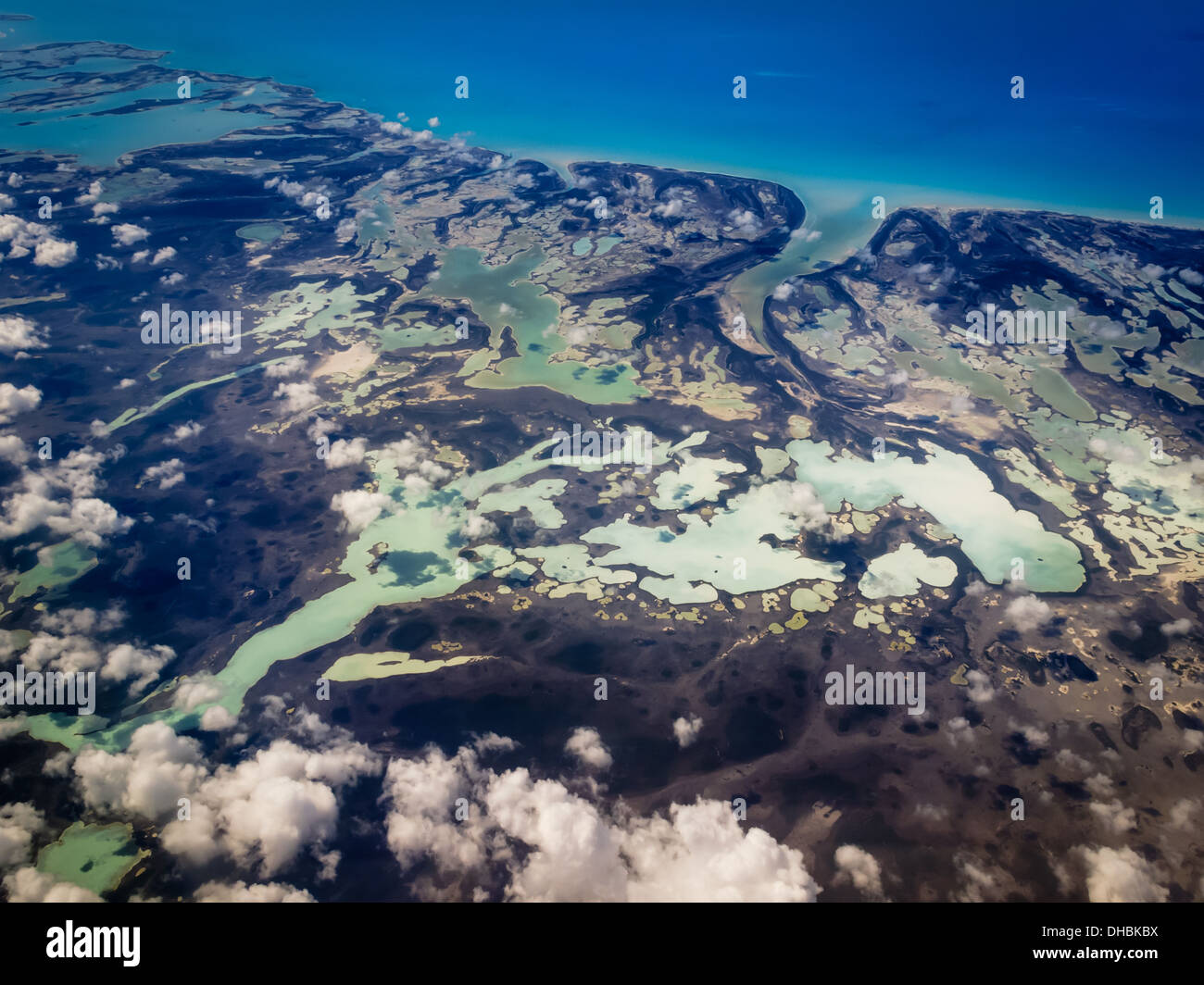 Vista aérea del Caribe Islas Bahamas distintas tonalidades de verdes y azules marmolados por tierra contornos Foto de stock