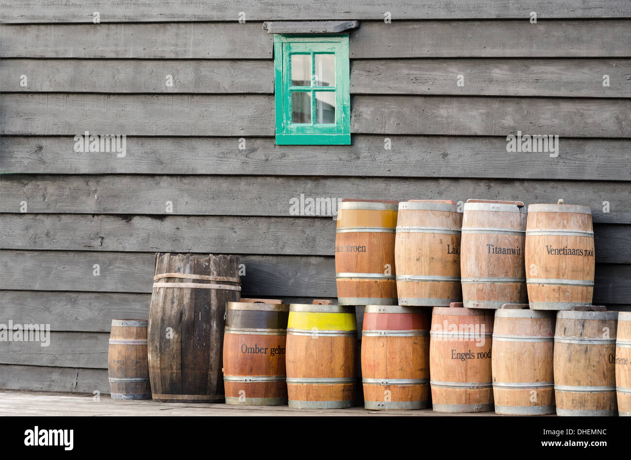 Pigmento de barriles apilados a lo largo de la pared de un molino de viento holandés. Con el pigmento está hecha la pintura de aceite. Foto de stock